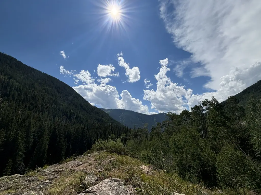 A high-country trail winding through an open mountain landscape